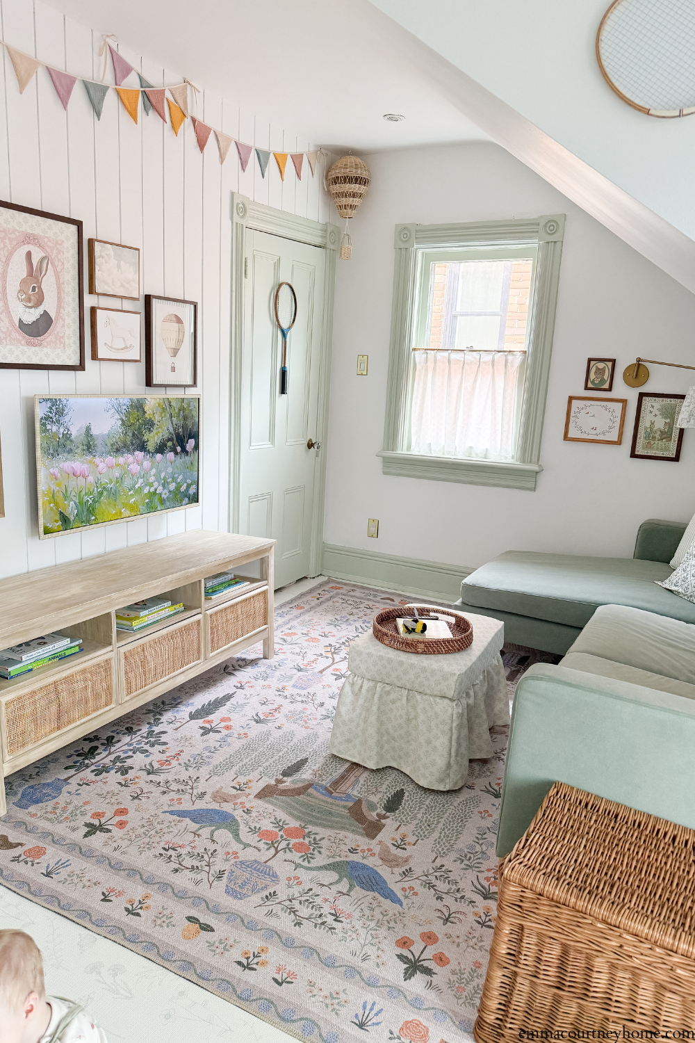 Bright and airy playroom after makeover with white walls and green trim