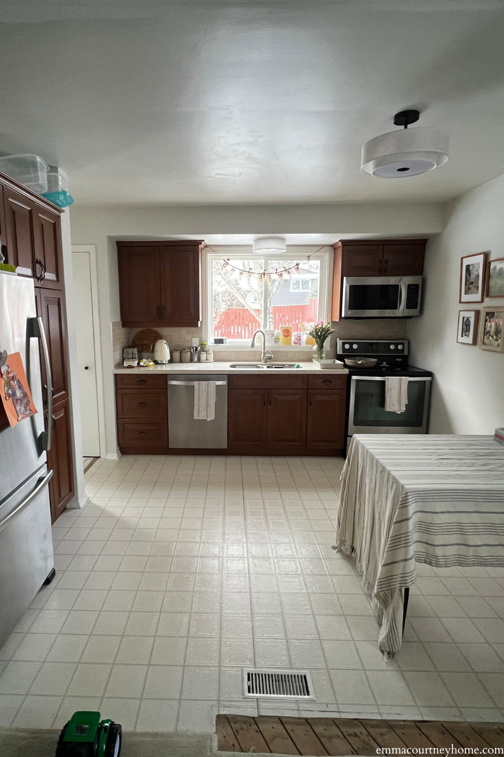 Before budget-friendly kitchen makeover with dark wood cabinets and linoleum flooring