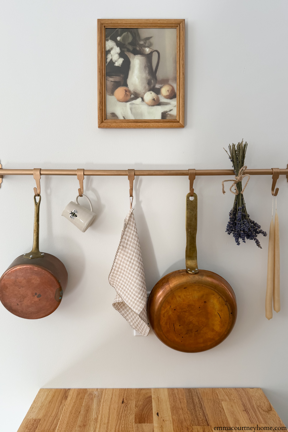 IKEA pot rack installed over peninsula in a budget-friendly kitchen makeover