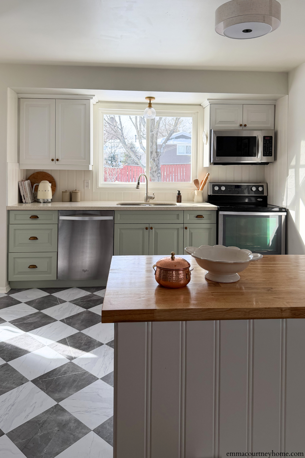 Bright kitchen after a budget-friendly kitchen makeover with IKEA peninsula and breakfast nook