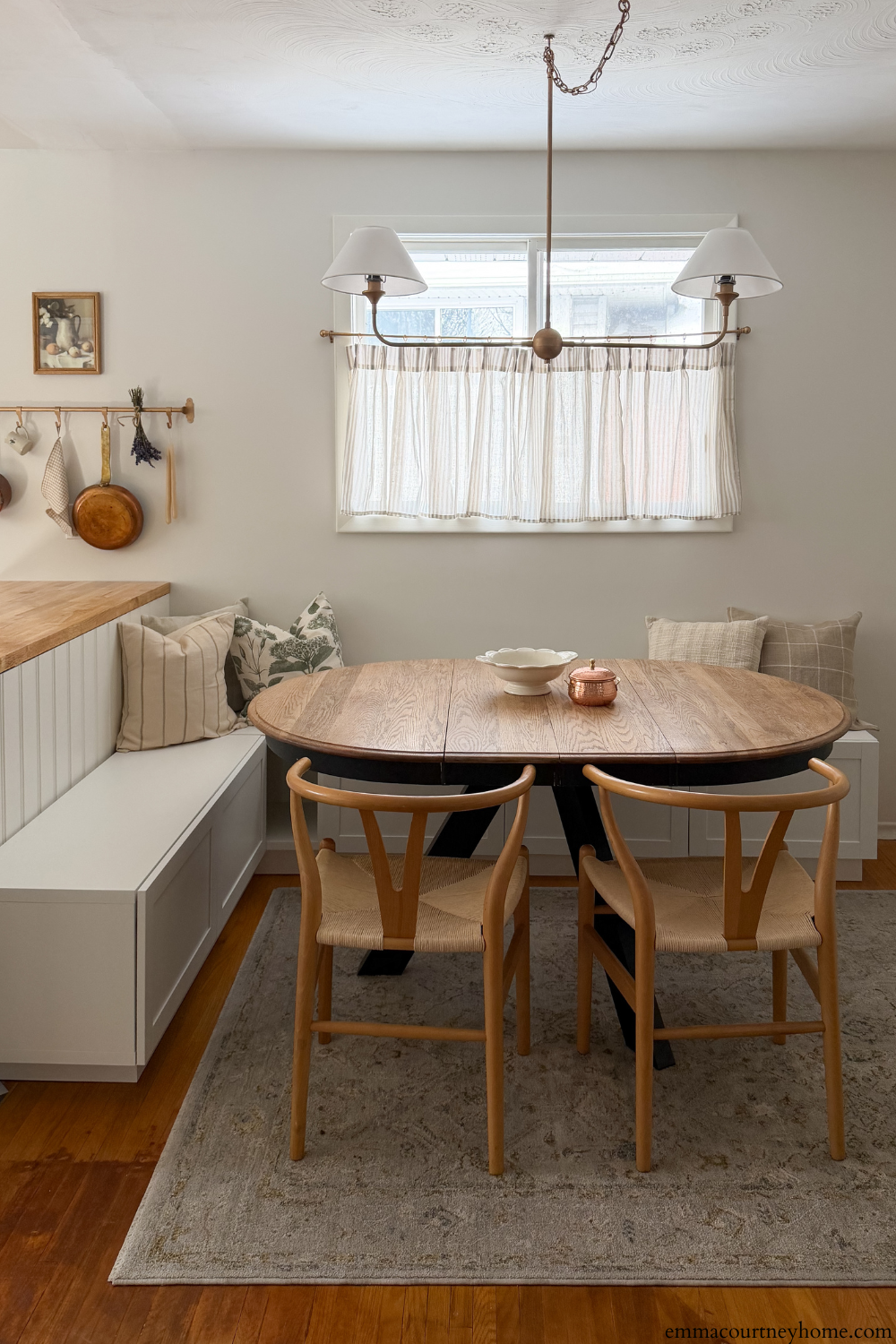 DIY breakfast nook banquette using IKEA Besta cabinets beside kitchen peninsula